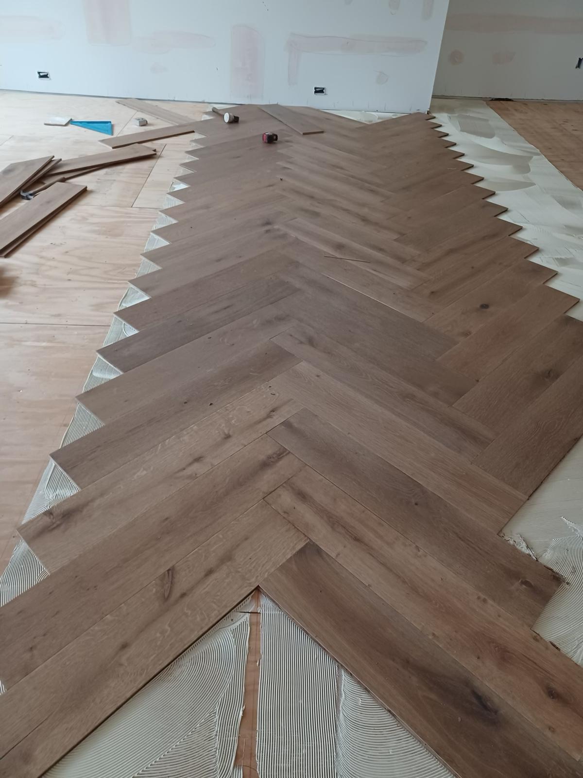Beautiful herringbone hardwood flooring by Mark's Flooring Zone